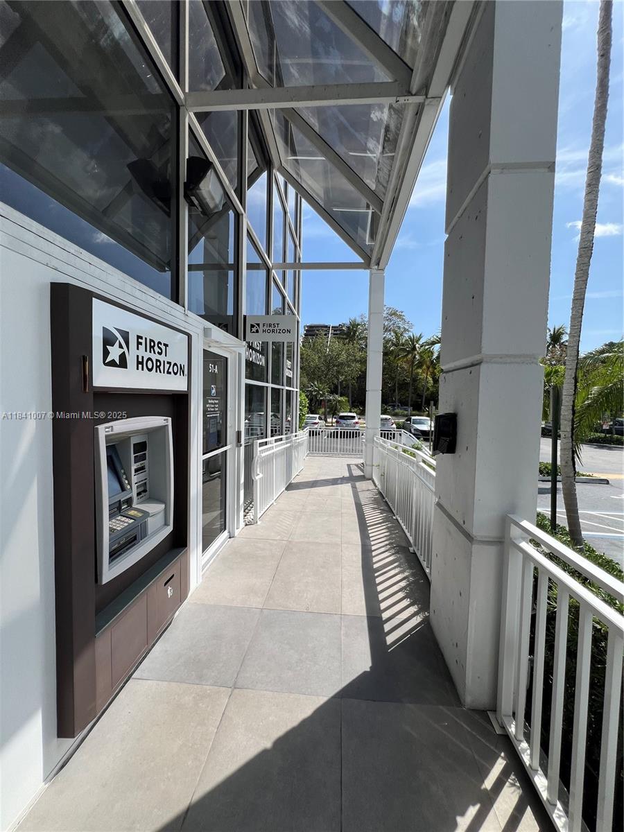An exterior walkway leads to a First Horizon bank branch with an ATM and glass facade — 260 Crandon Blvd # A51, Key Biscayne FL 33149, KEY BISCAYNE, FL