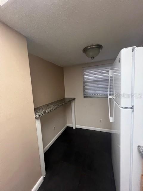 A kitchen features light wood cabinets, granite countertops, a white stove, and a white dishwasher — 3700 S OSPREY AVENUE UNIT 221, SARASOTA, FL