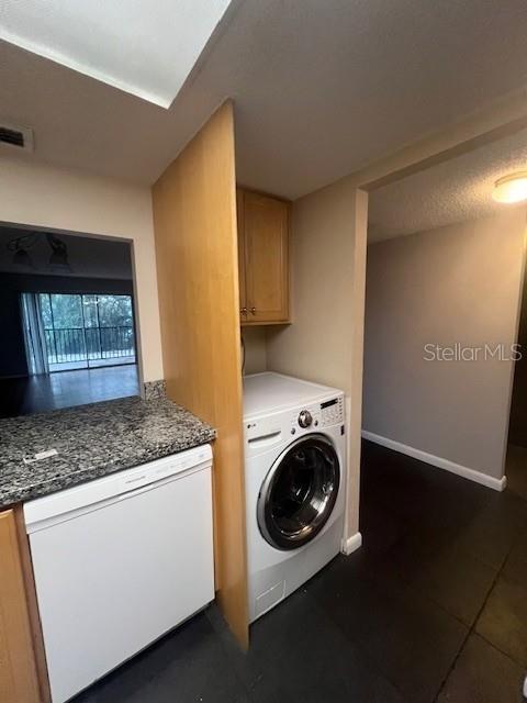 A kitchen features light wood cabinets, granite countertops, and white appliances — 3700 S OSPREY AVENUE UNIT 221, SARASOTA, FL