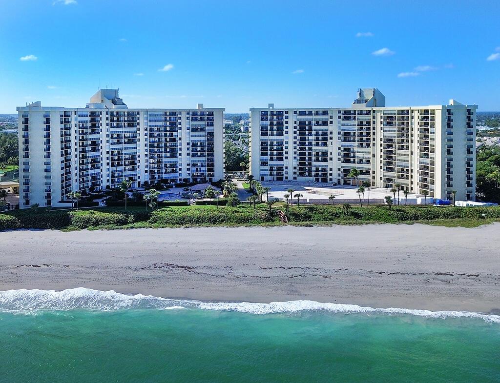An aerial view of two large beachfront apartment buildings situated behind a sandy beach — 400 Ocean Trail Way # 203, Jupiter FL 33477, JUPITER, FL