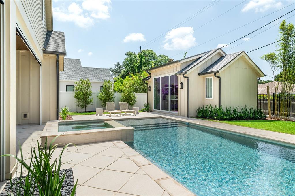 A backyard features a swimming pool with an attached spa, patio, and a detached structure — 1204 NOTTINGHAM STREET, ORLANDO, FL