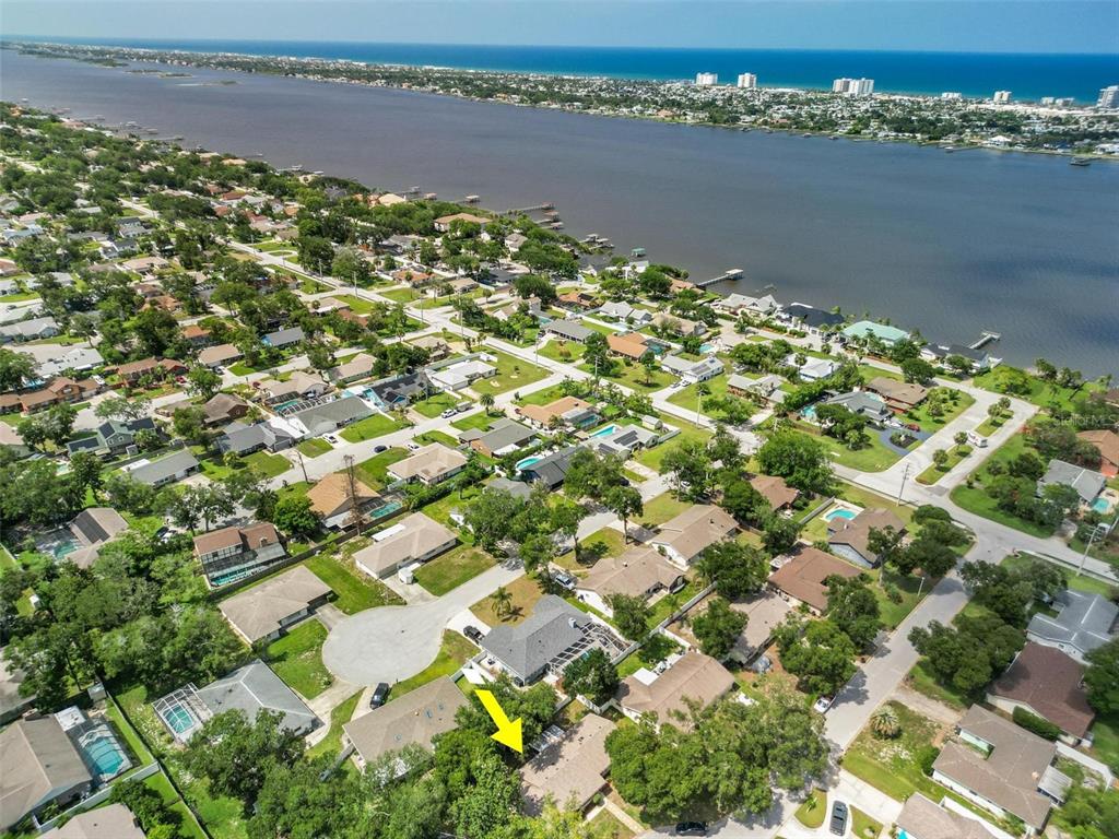 An aerial view shows a residential neighborhood with a yellow arrow pointing to a house — 9 BRIDGET TERRACE, ORMOND BEACH, FL