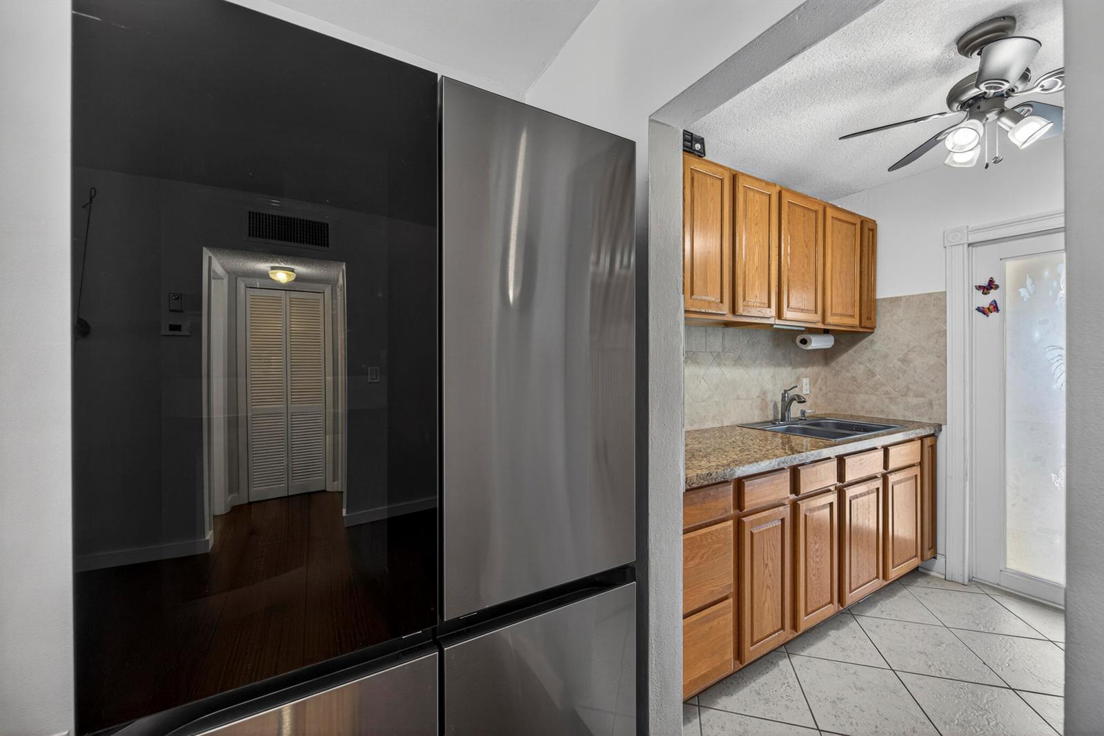 A bathroom features a white vanity, a toilet, a shower stall, and a storage unit — 2475 W Golf Boulevard # 247, Pompano Beach FL 33064, POMPANO BEACH, FL