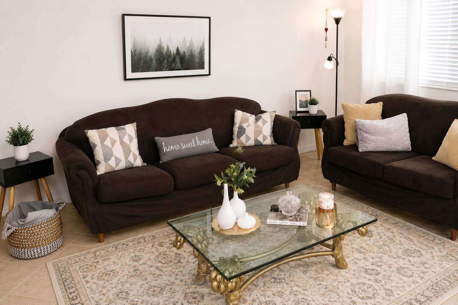 A living room features two brown sofas, a glass coffee table, and a patterned rug — 148 Tuscany # B, Delray Beach FL 33446, DELRAY BEACH, FL
