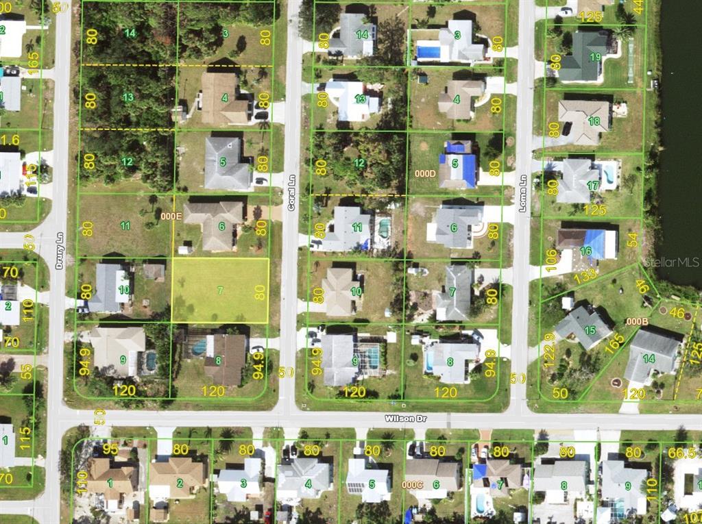 An aerial view shows a vacant, rectangular residential lot outlined in red between two houses — 1274 CORAL LANE, ENGLEWOOD, FL