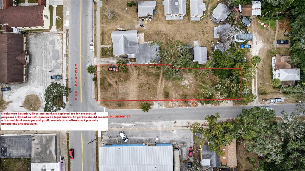 An aerial view shows a vacant rectangular lot outlined in red between two streets — MADISON AVENUE, DAYTONA BEACH, FL
