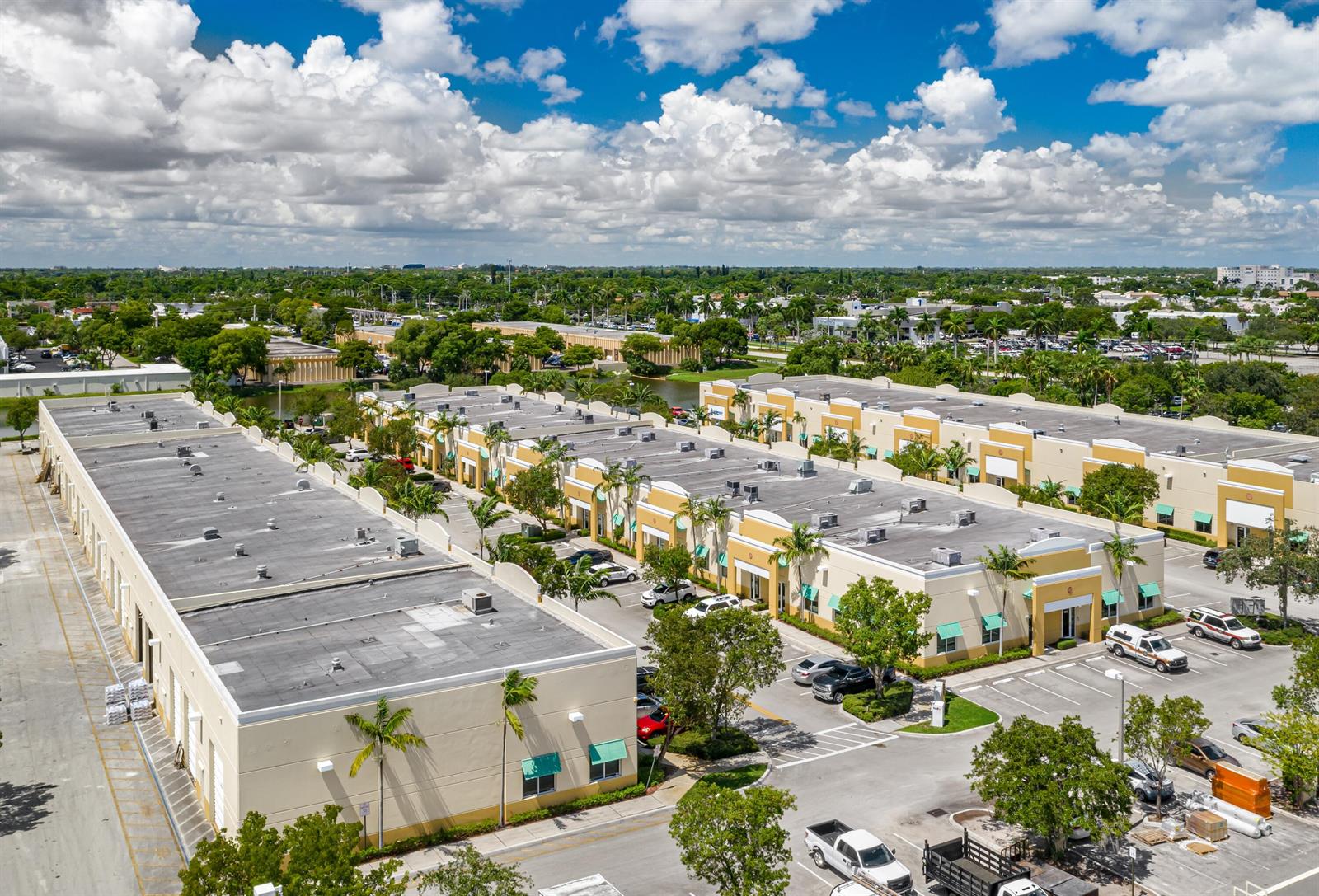 An aerial view shows a commercial business park with multiple tan buildings and parking lots — 1857 Banks Road # 1859, Margate FL 33063, MARGATE, FL