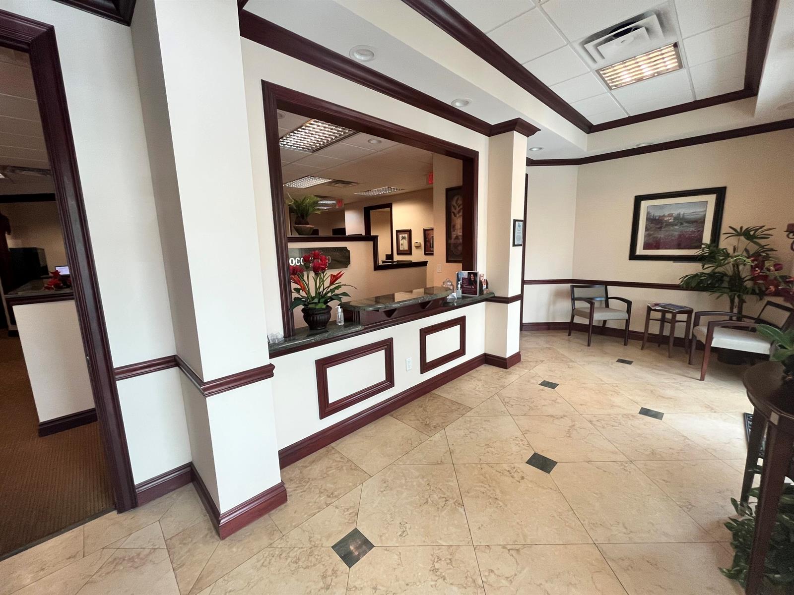 A reception area features a service window, tile flooring, and a small waiting area — 1857 Banks Road # 1859, Margate FL 33063, MARGATE, FL