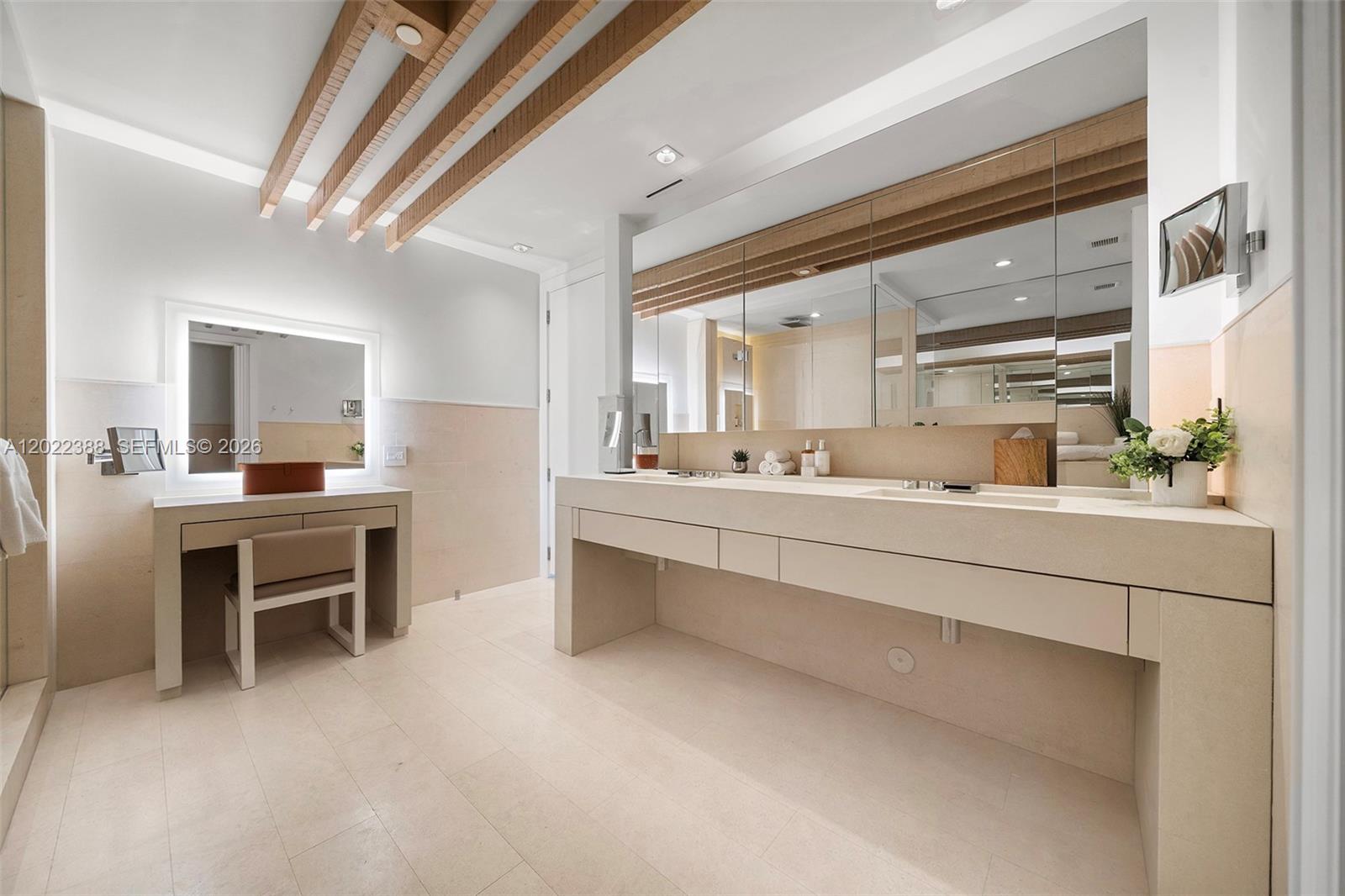 A modern bathroom features a double vanity, a separate makeup desk, and wooden ceiling beams — 102 24th St # 1718, Miami Beach FL 33139, MIAMI BEACH, FL