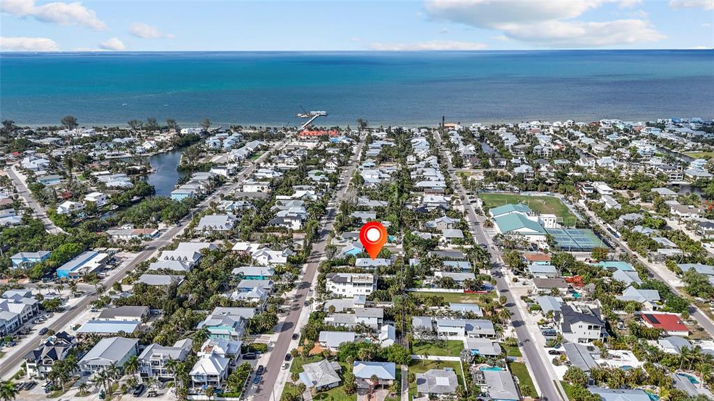 An aerial view shows a coastal neighborhood with a red location pin over a house — 315 SPRING AVENUE, ANNA MARIA, FL