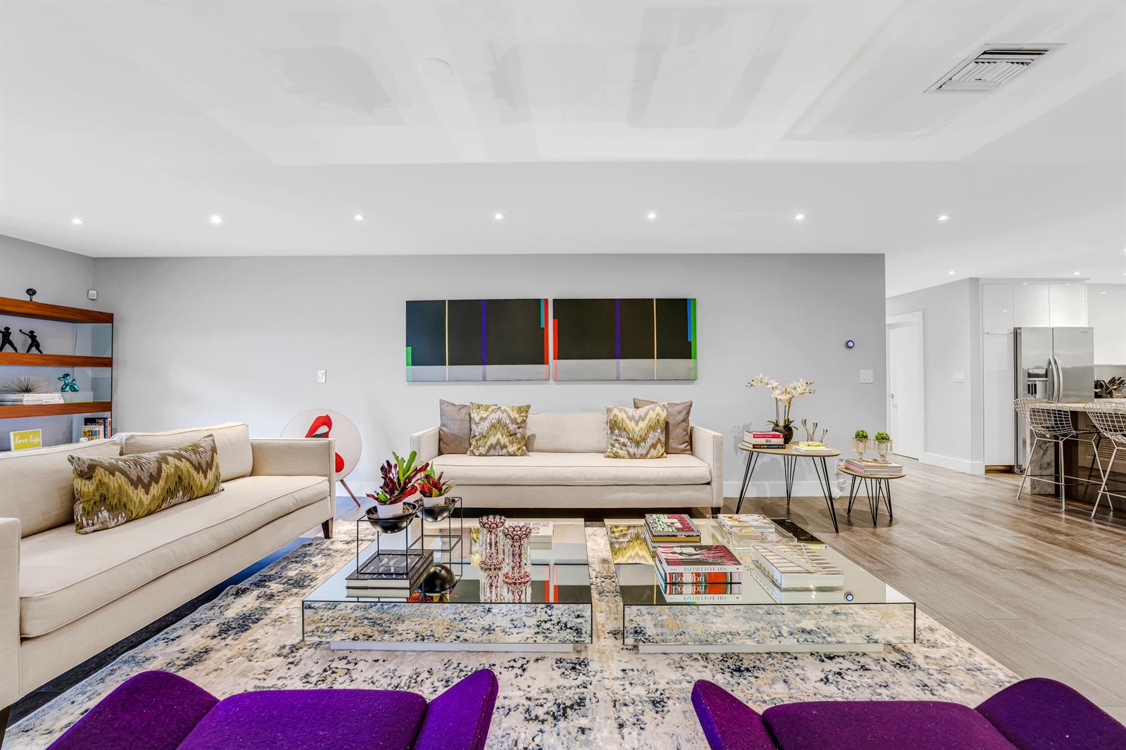 A modern living room features two beige sofas, mirrored coffee tables, and purple accent chairs — 908 Cypress Grove Drive, Pompano Beach FL 33069, POMPANO BEACH, FL