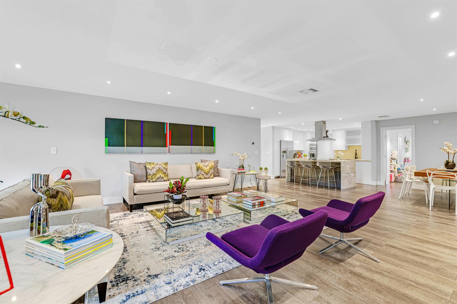 An open-concept living room features a beige sofa, two purple armchairs, and a modern kitchen — 908 Cypress Grove Drive, Pompano Beach FL 33069, POMPANO BEACH, FL