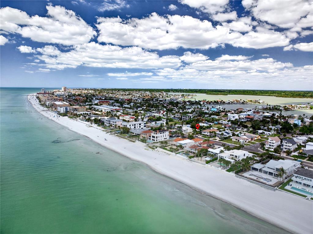 An aerial view shows a beachfront neighborhood with a red pin marking a specific property — 16107 GULF BOULEVARD, REDINGTON BEACH, FL