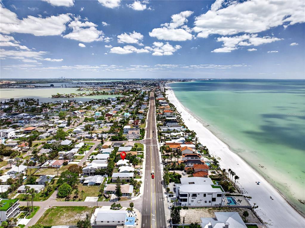 An aerial view shows a coastal neighborhood with a red marker on a residential property — 16107 GULF BOULEVARD, REDINGTON BEACH, FL