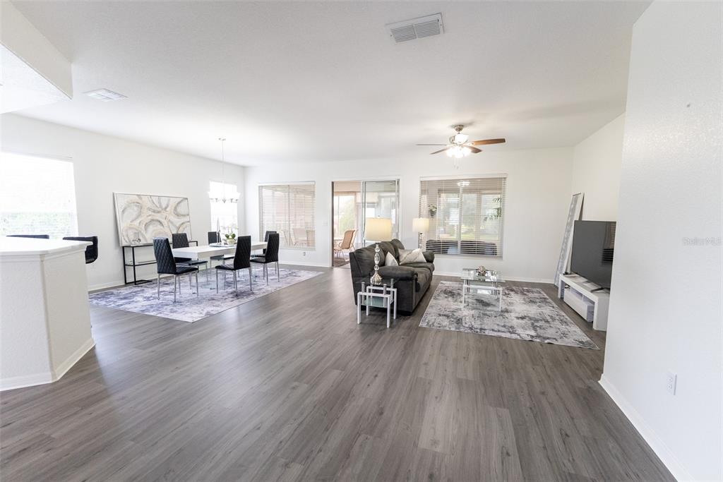 A kitchen features wood cabinets, stainless steel appliances, and white marble-look countertops — 12855 SE 92ND COURT ROAD, SUMMERFIELD, FL