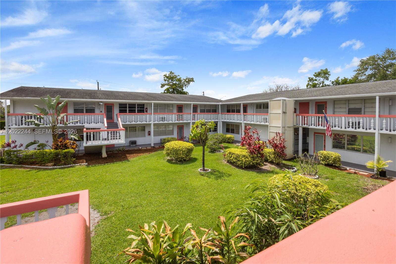 A two-story apartment complex surrounds a central grassy courtyard with landscaping and walkways — 75 Ventnor D # 75, Deerfield Beach FL 33442, DEERFIELD BEACH, FL