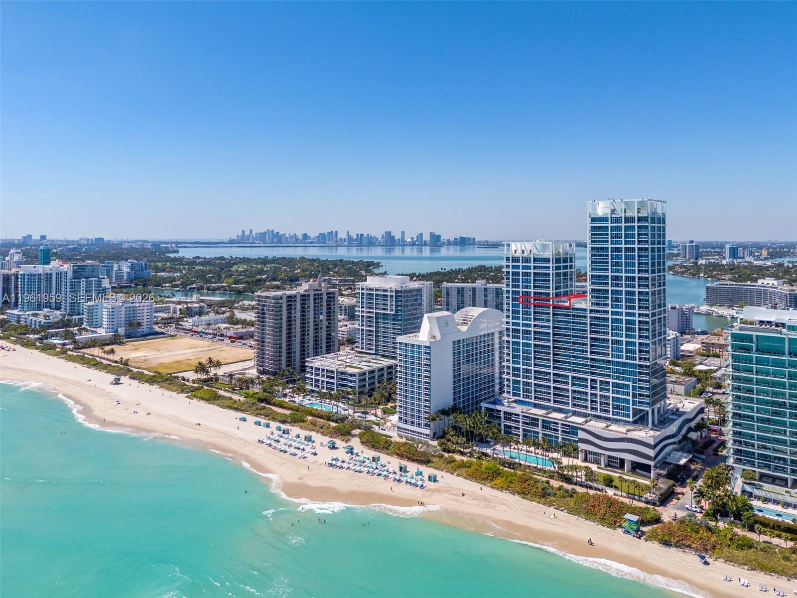 An aerial view of a coastal city featuring high-rise buildings along a sandy beach — 6899 Collins Ave, Miami Beach FL 33141, MIAMI BEACH, FL