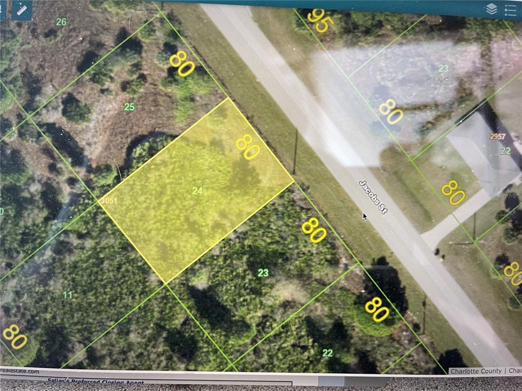 This is a satellite map showing a highlighted rectangular plot of land along a road — 2379 JACOBS STREET, PORT CHARLOTTE, FL