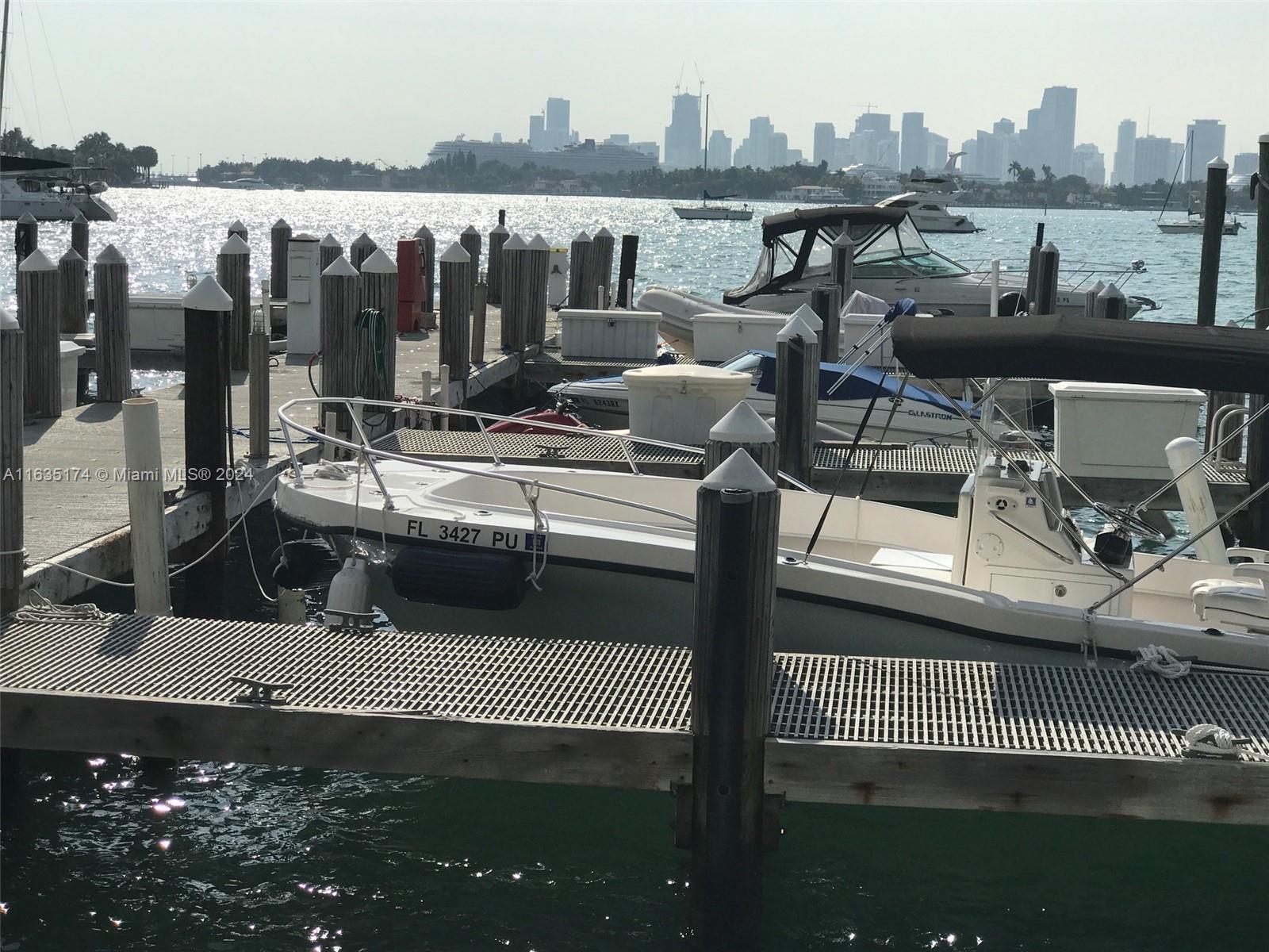 A marina features several docked boats with a city skyline visible in the background — 1500 Bay Rd # 522S, Miami Beach FL 33139, MIAMI BEACH, FL