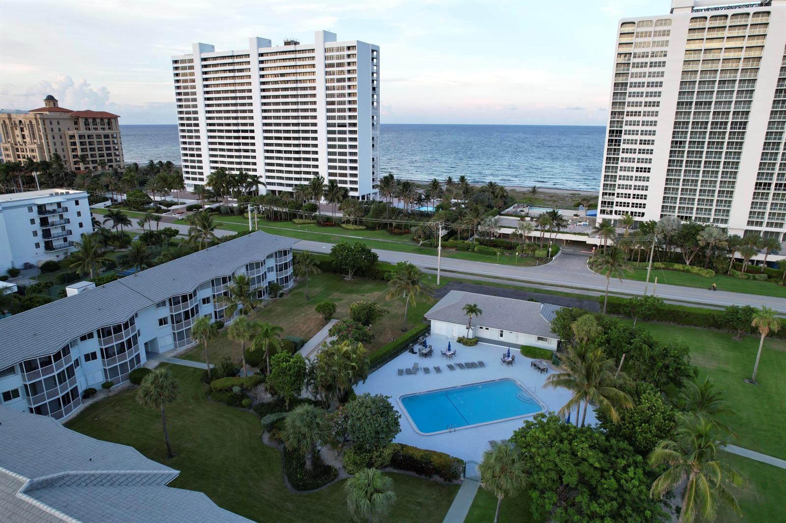 An aerial view shows a swimming pool, a low-rise apartment building, and two high-rise towers — 2700 Banyan Road # 3, Boca Raton FL 33432, BOCA RATON, FL