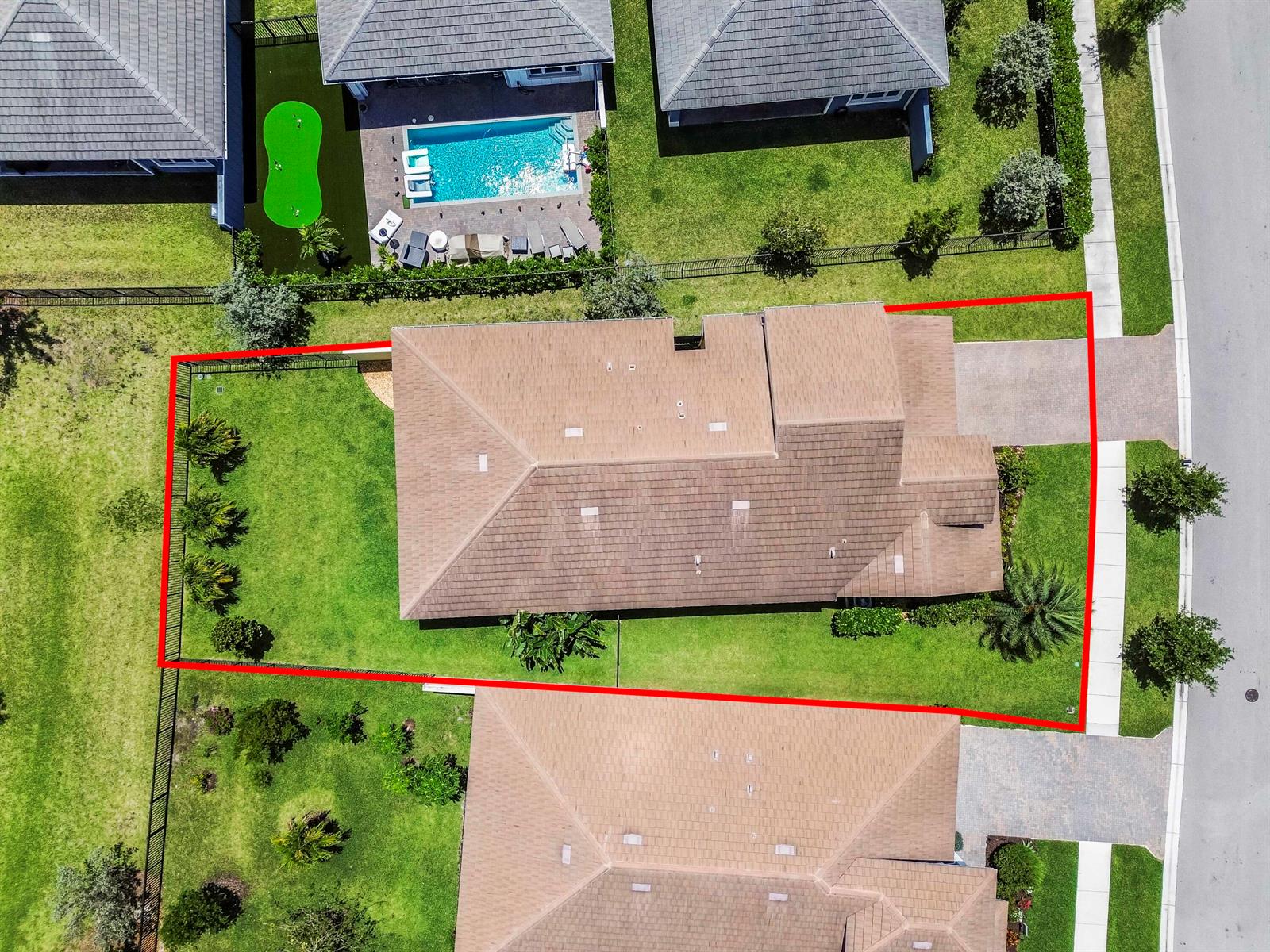 An aerial view shows a single-family home with a fenced backyard and a paved driveway — 1338 Harvester Crossing, Loxahatchee FL 33470, LOXAHATCHEE, FL