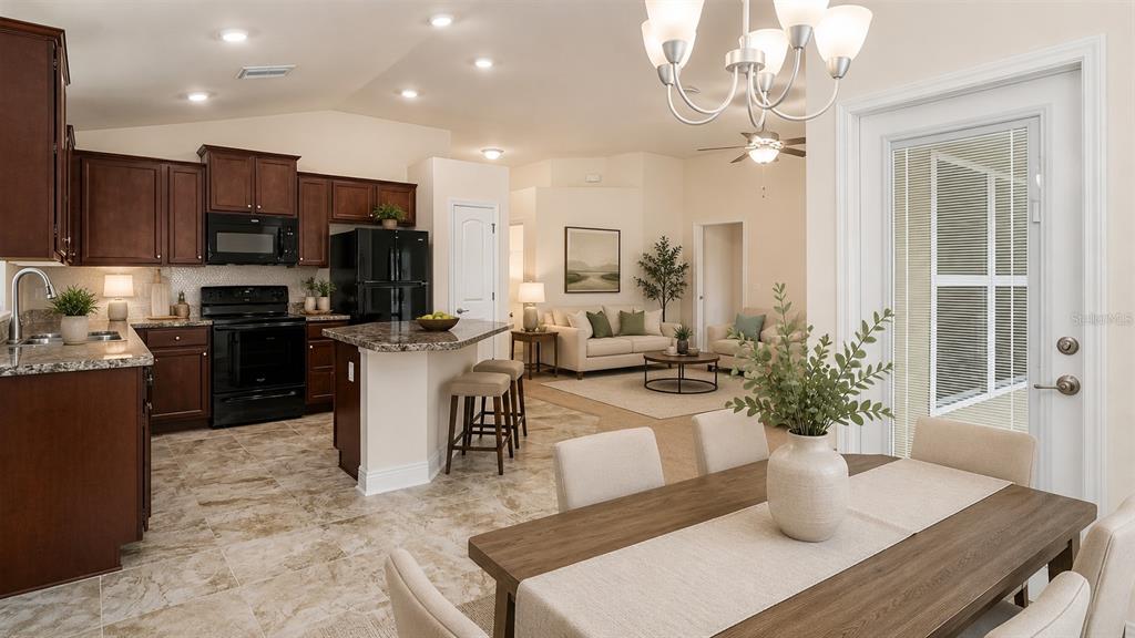 An open-concept kitchen, dining area, and living room featuring dark wood cabinets and tile floors — 7172 SHERMAN HILLS BOULEVARD, BROOKSVILLE, FL