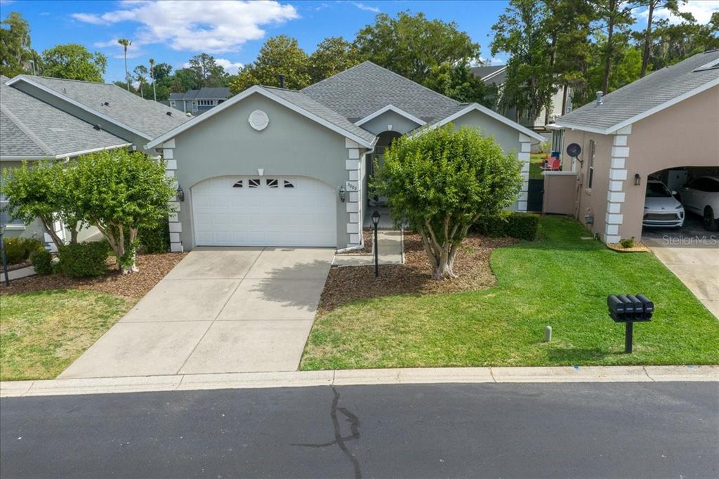 A single-story house with a two-car garage, a gray exterior, and a front lawn — 3003 SW 41ST PLACE, OCALA, FL