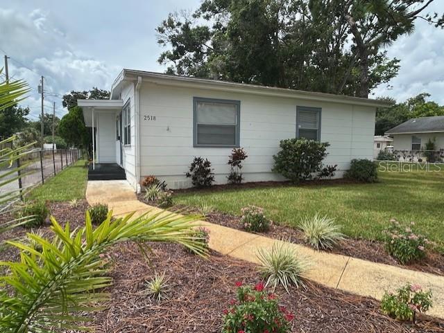 A white single-story house features a concrete walkway leading to the front entrance — 2518 40TH AVENUE N, ST PETERSBURG, FL