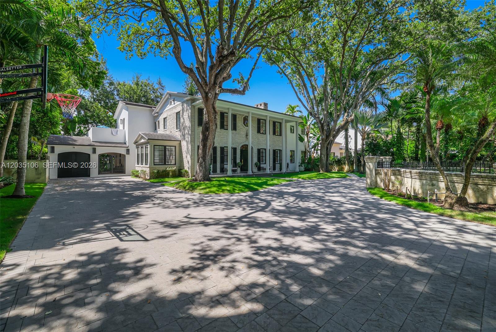 A large two-story house with a paved driveway, mature trees, and a basketball hoop — 3120 Brickell Ave, Miami FL 33129, MIAMI, FL
