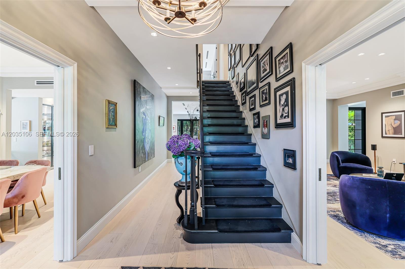 A central staircase with black treads and a gallery wall leads through a bright foyer — 3120 Brickell Ave, Miami FL 33129, MIAMI, FL