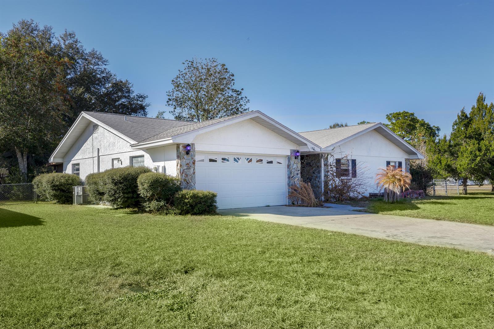 A single-story house with a white exterior, stone accents, and a two-car garage — 4262 S Centennial Avenue, FL 34446, FL