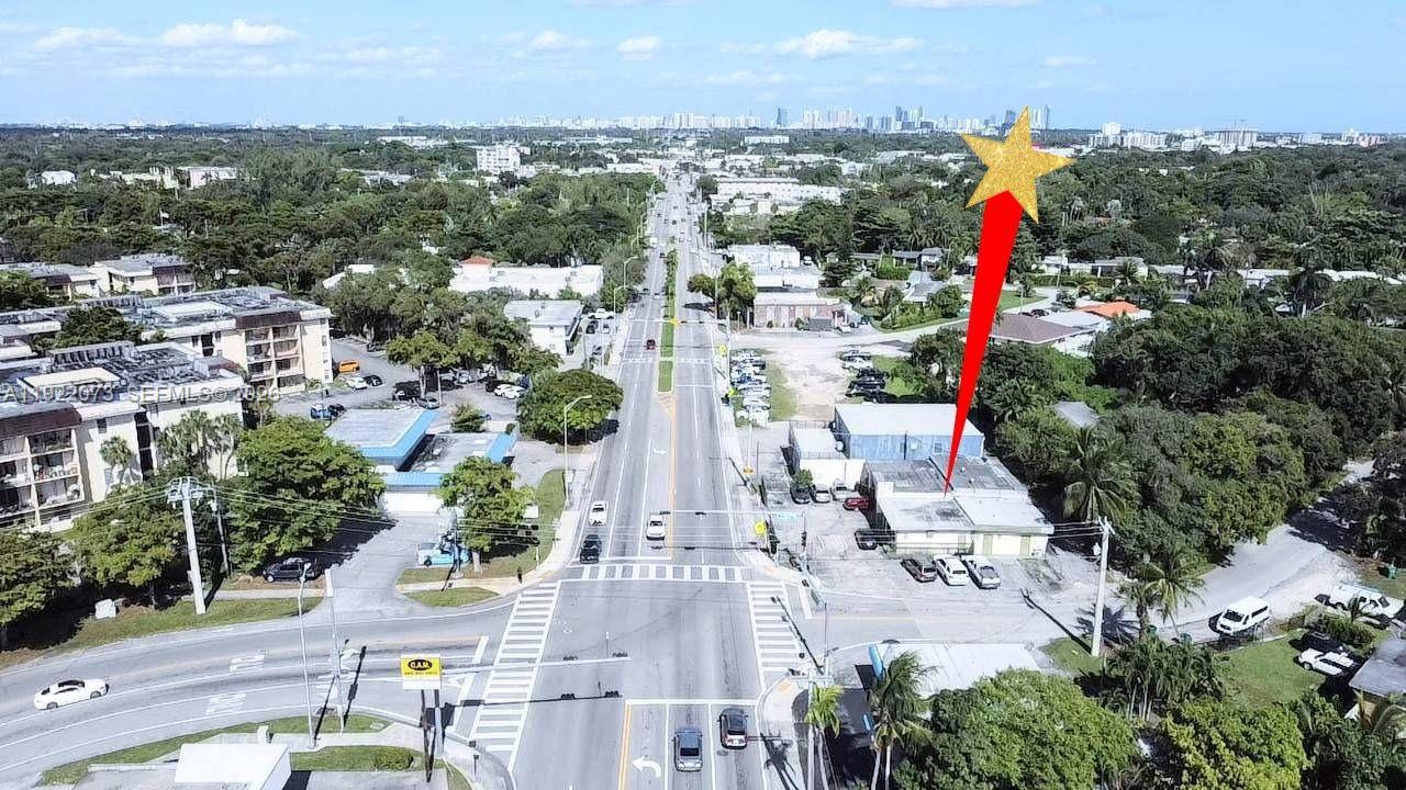 An aerial view shows a commercial building marked with a star near a busy intersection — 11851 W Dixie Hwy, Miami FL 33161, MIAMI, FL
