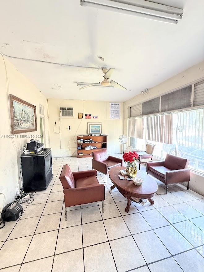 A waiting room features tiled floors, three leather armchairs, and a central wooden coffee table — 11851 W Dixie Hwy, Miami FL 33161, MIAMI, FL