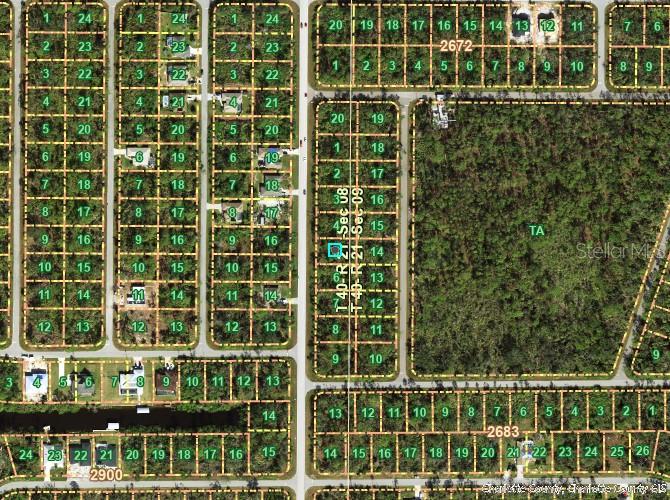 This is an aerial map showing a grid of residential land parcels and undeveloped wooded lots — 1296 JACOBS STREET, PORT CHARLOTTE, FL