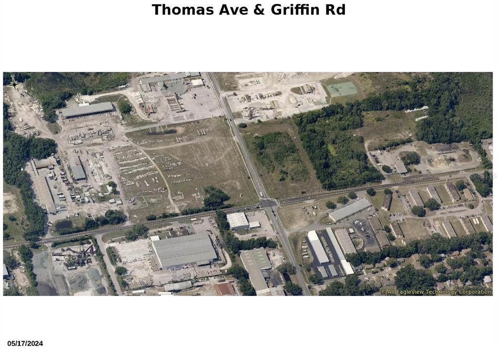 This aerial map shows an intersection surrounded by industrial buildings, vacant land, and wooded areas — GRIFFIN RD & THOMAS AVENUE, LEESBURG, FL