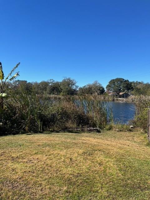 A sunset view over a pond with a small white building in the foreground — 8841 S MOBLEY ROAD, ODESSA, FL