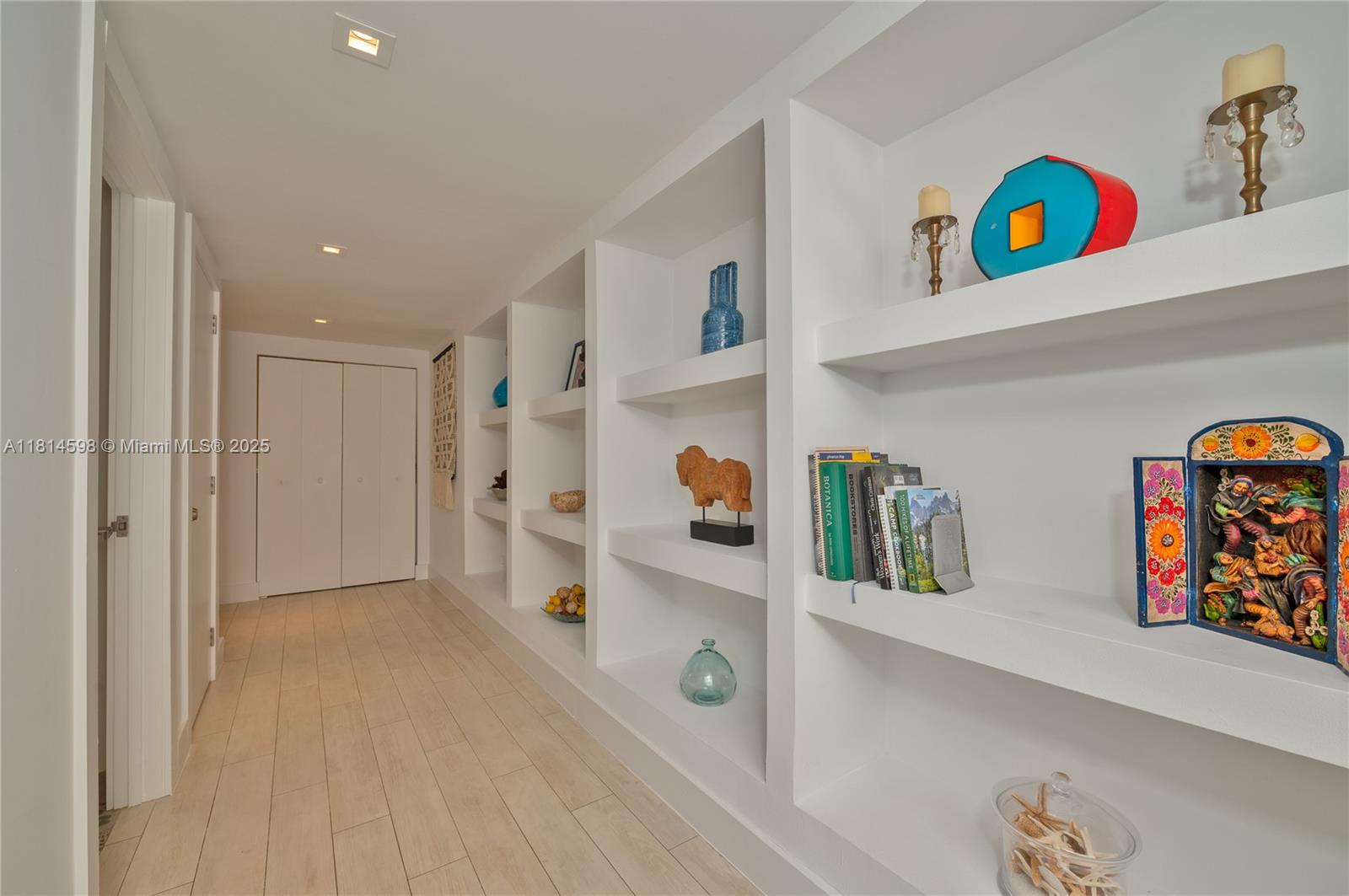 A hallway features white built-in shelving, light wood-look tile floors, and recessed ceiling lighting — 101 Crandon Blvd # 480, Key Biscayne FL 33149, KEY BISCAYNE, FL