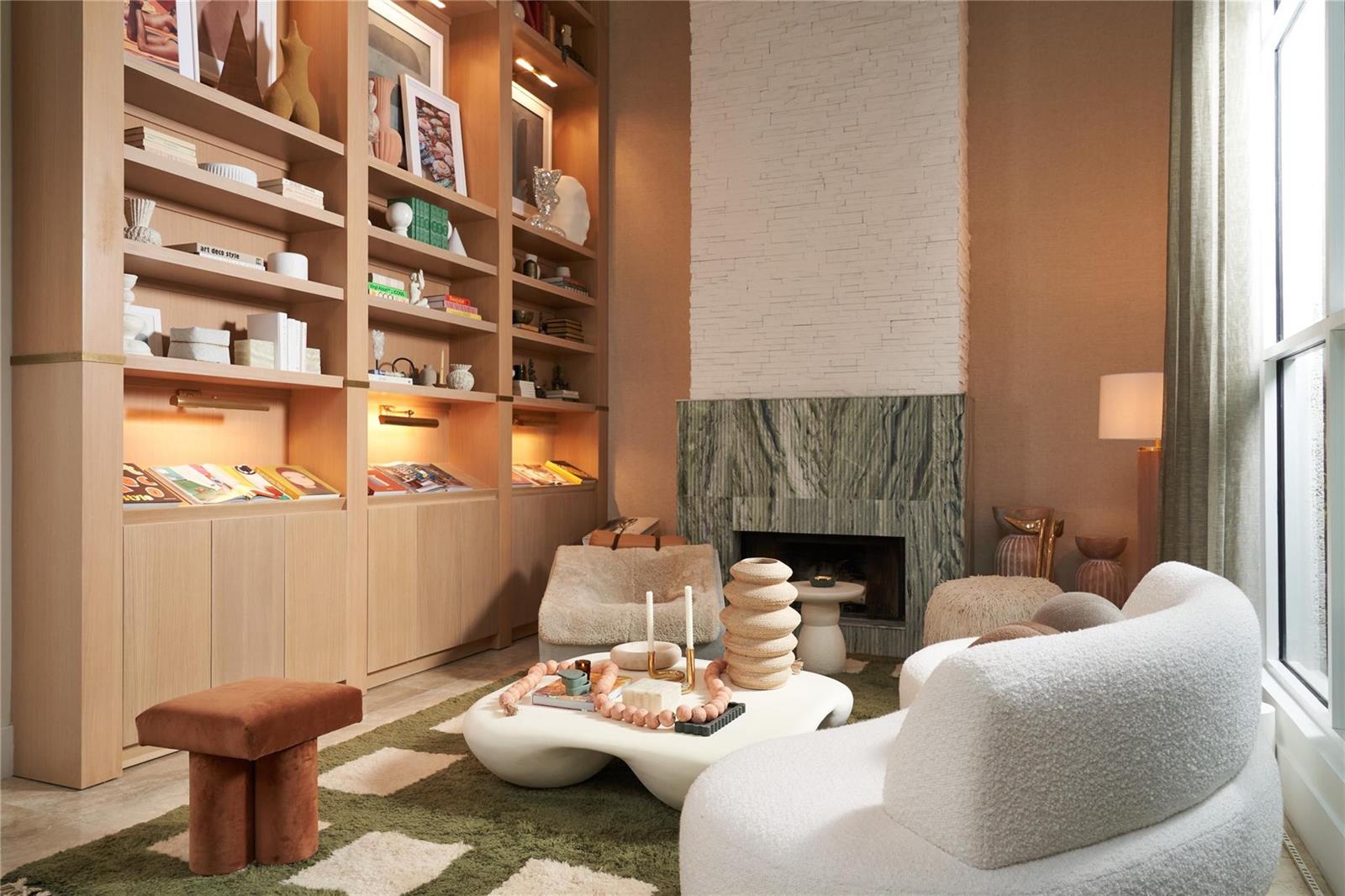 A living room features built-in wooden bookshelves, a stone fireplace, and modern cream-colored furniture — 2765 Brickell Court, Miami FL 33129, MIAMI, FL