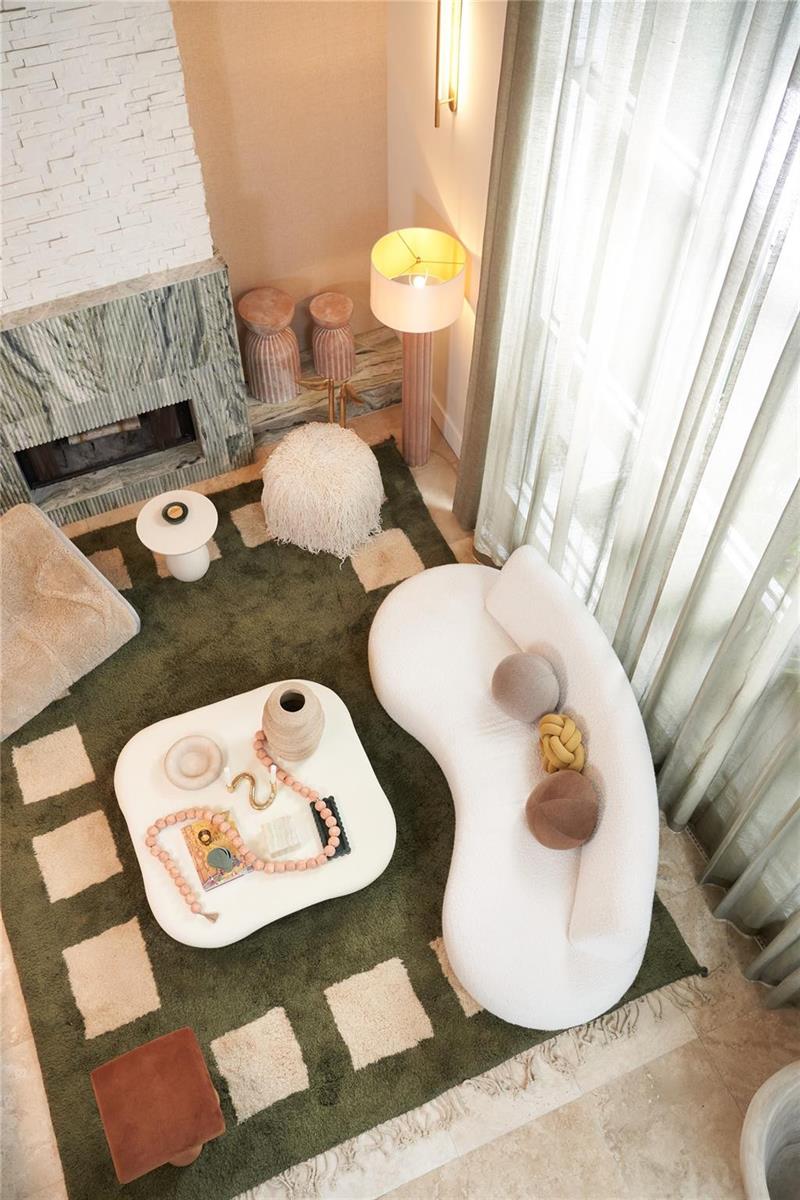 A high-angle view of a living room featuring a curved white sofa and green rug — 2765 Brickell Court, Miami FL 33129, MIAMI, FL