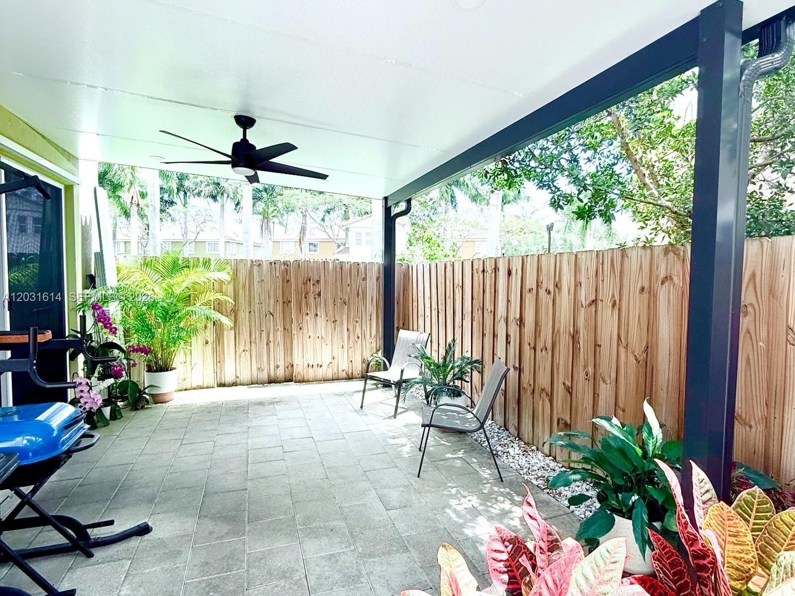 A dining area features a marble-topped table, four upholstered chairs, and a ceiling fan — HOMESTEAD, FL