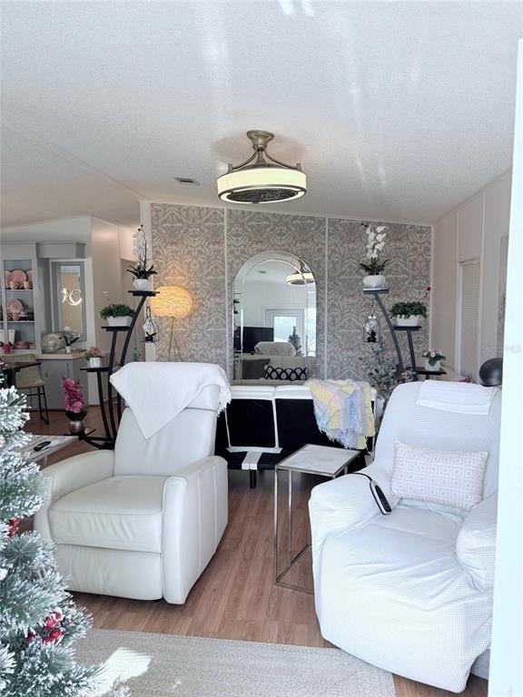 A screened-in porch entrance features a white door and a spiky plant in front — 3002 12TH STREET W, PALMETTO, FL