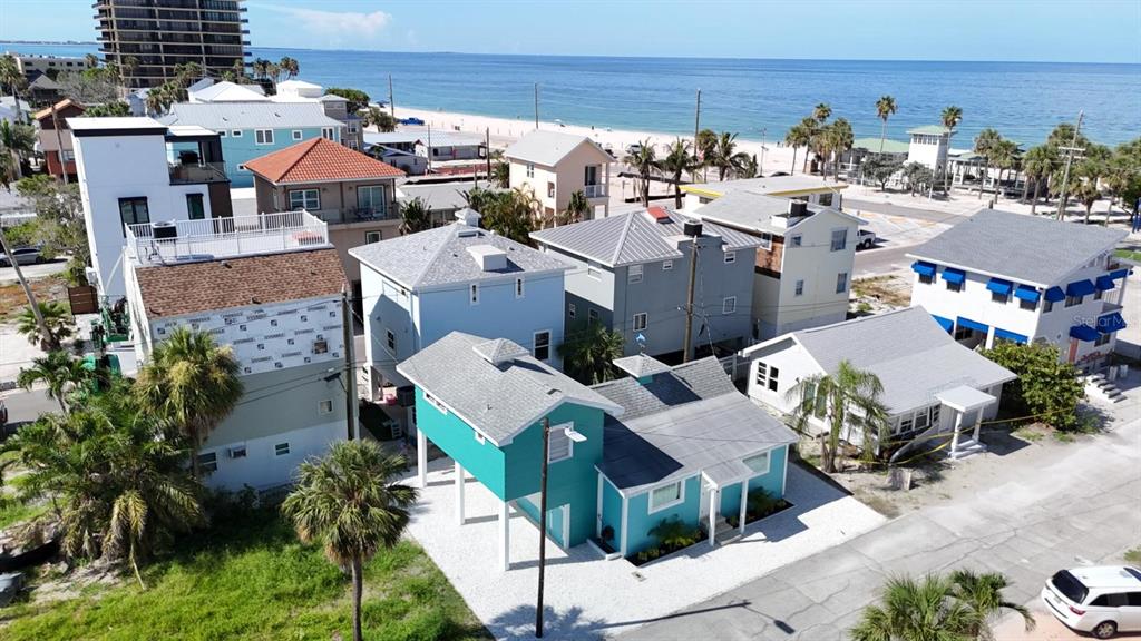An aerial view shows several coastal houses near a sandy beach and the ocean — 37 80TH TERRACE, TREASURE ISLAND, FL