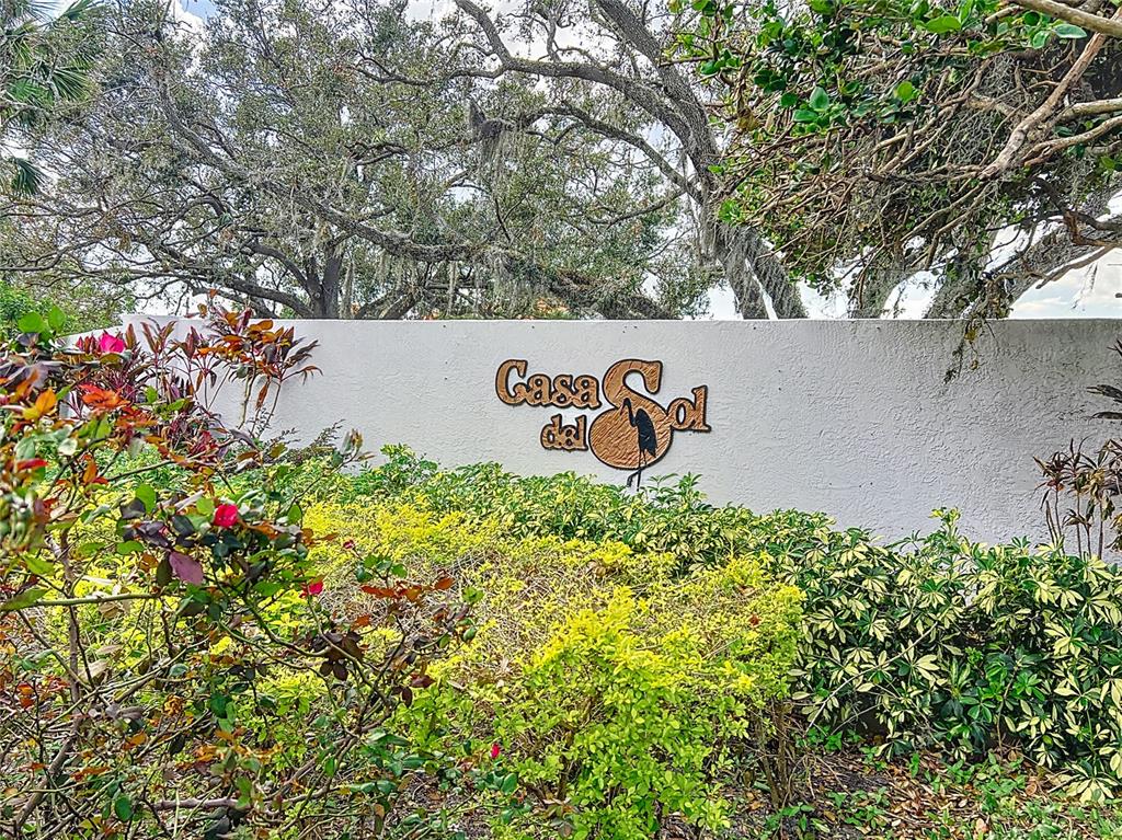 A white wall features a sign reading Casa del Sol surrounded by trees and landscaping — 4382 MADEIRA COURT UNIT 3361, SARASOTA, FL