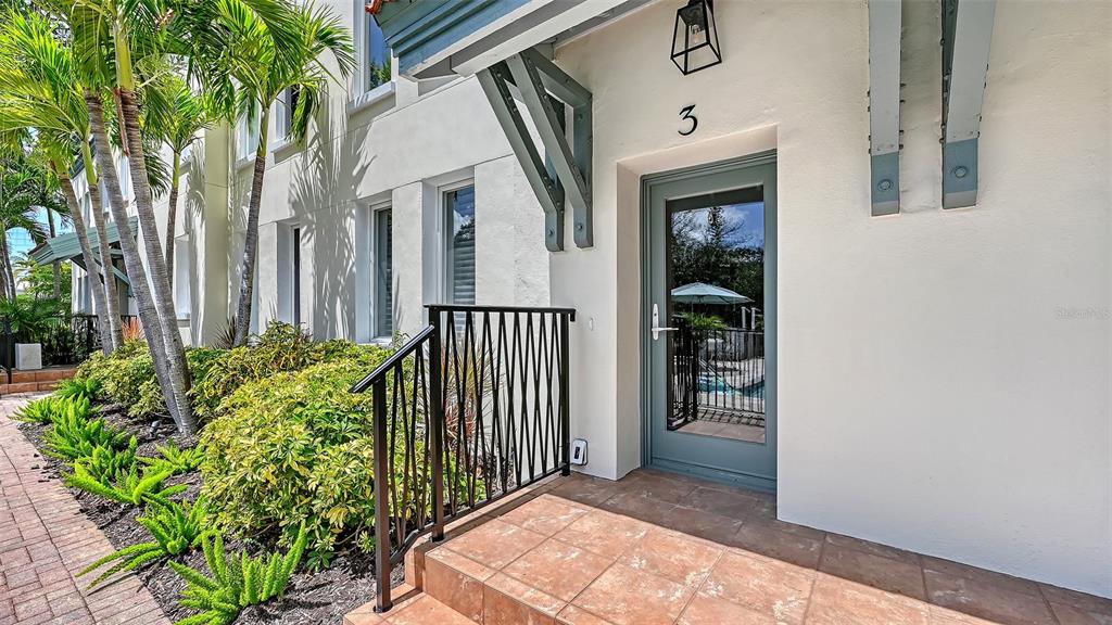 An exterior view of a building entrance with a glass door labeled number three — 1685 LAUREL STREET UNIT 3, SARASOTA, FL
