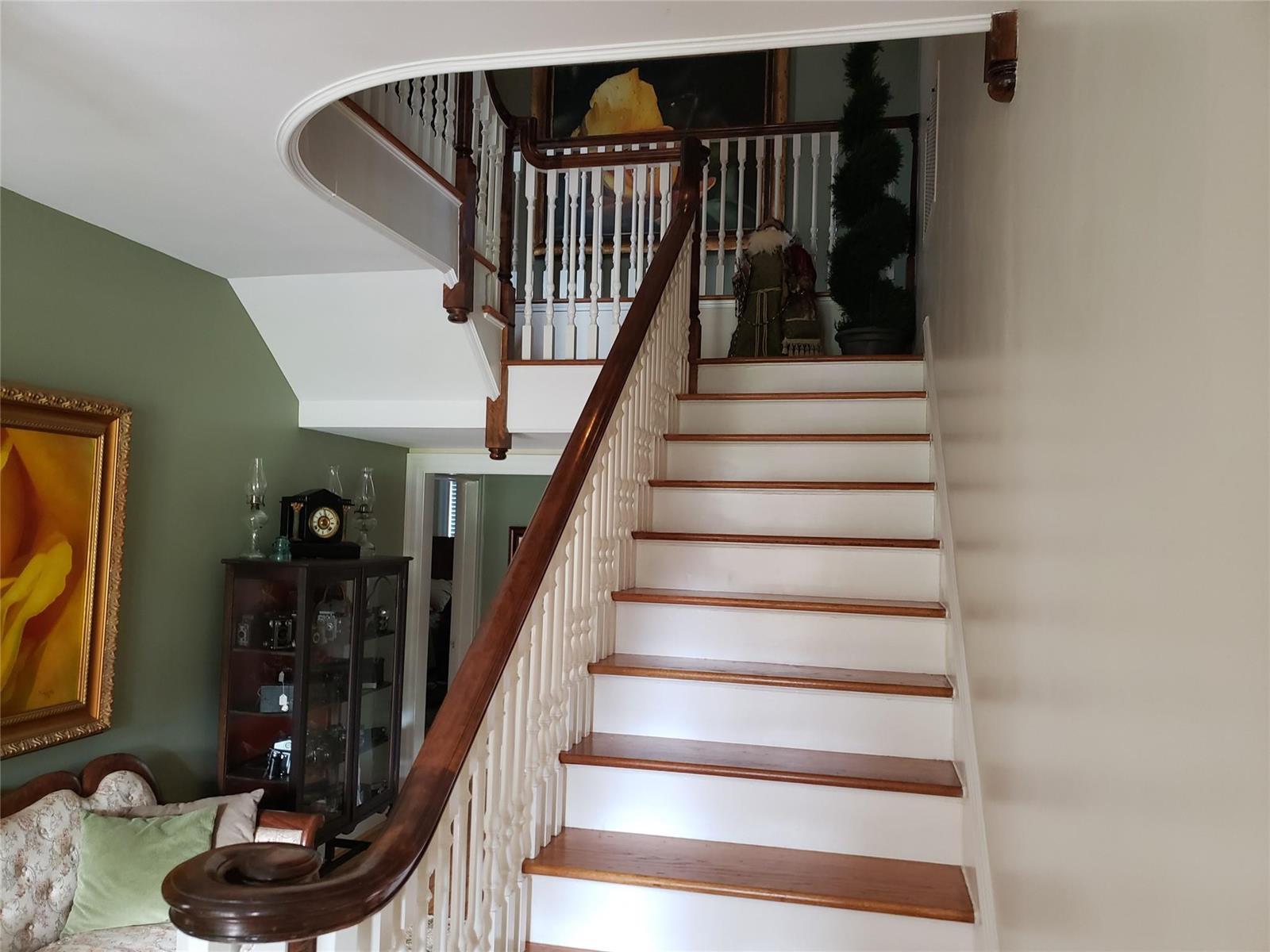 A staircase with white risers and wood treads leads to a landing with a railing — 310 Woodland Drive, NC, NC