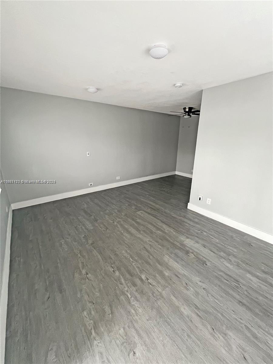 An empty room features light gray walls and wood-look laminate flooring — 2783 - 2785 SW 33rd Ct, Miami FL 33133, MIAMI, FL