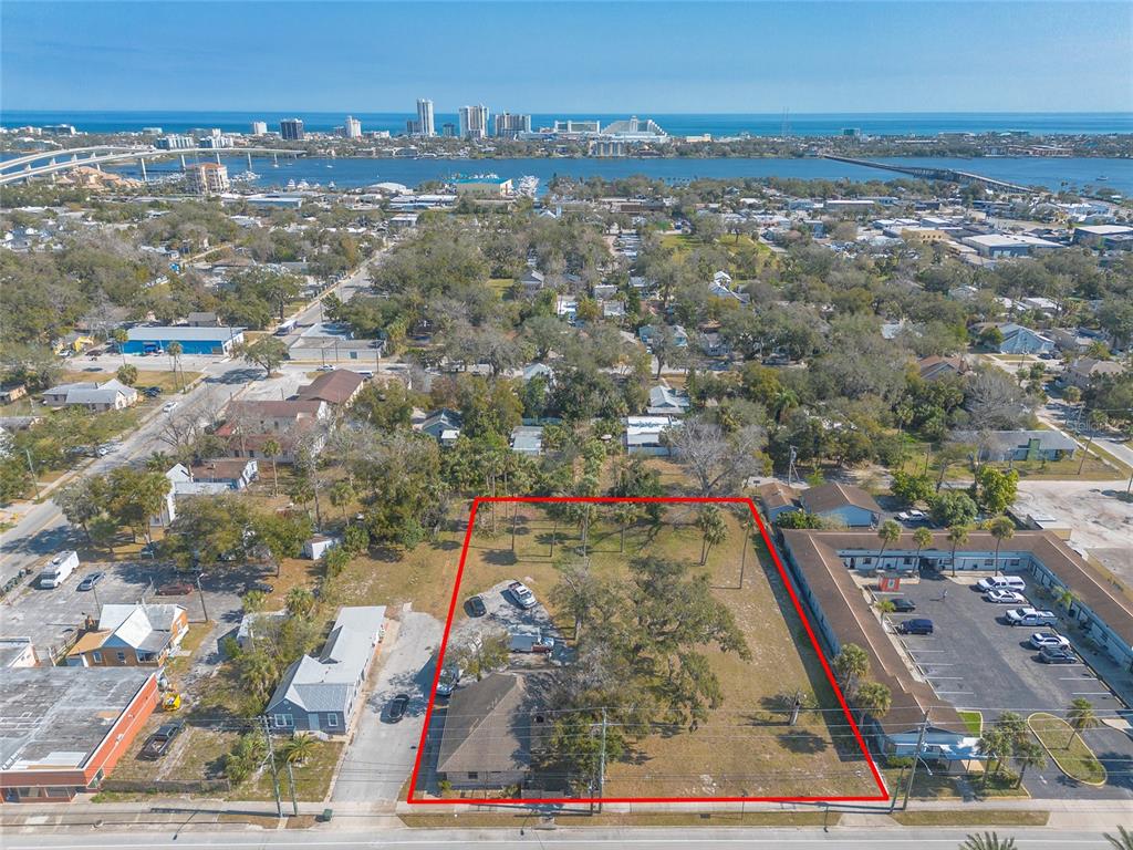 An aerial view shows a rectangular lot with a house and trees outlined in red — 631 N RIDGEWOOD AVENUE, DAYTONA BEACH, FL