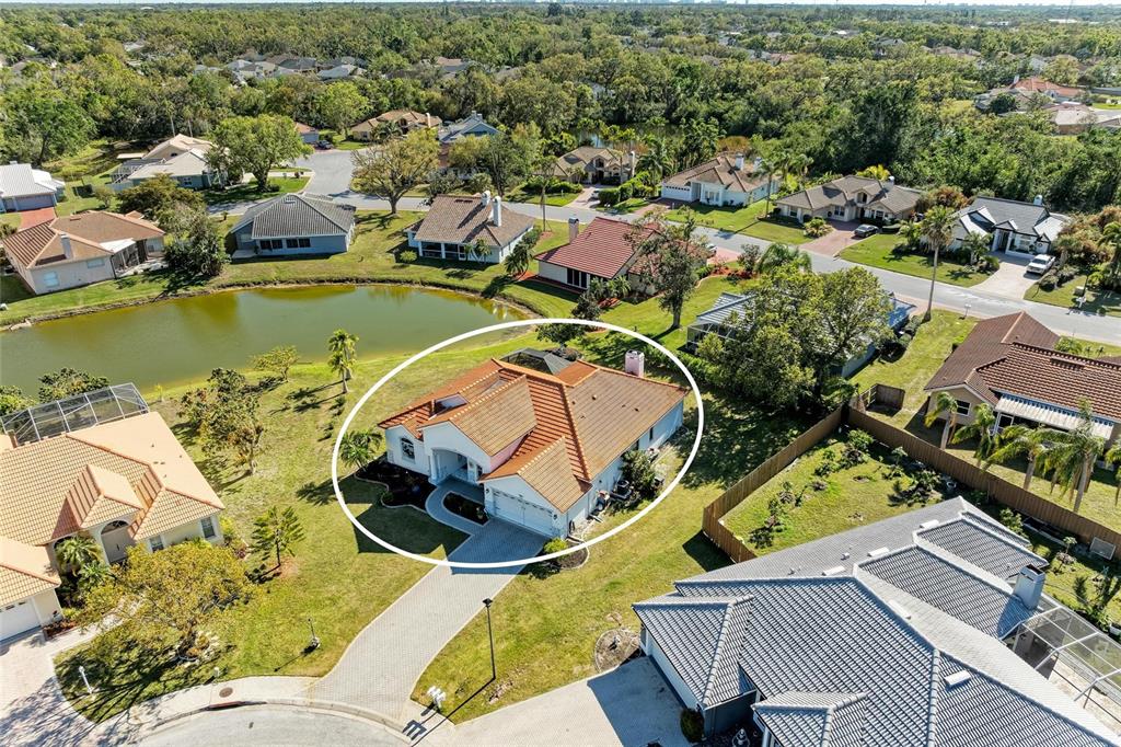 An aerial view shows a single-story house with a tile roof and a circular driveway — 7102 42ND COURT E, SARASOTA, FL