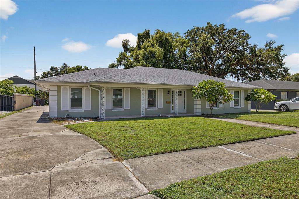 A single-story house with a light green exterior, white shutters, and a concrete driveway — 2502 VINE STREET, ORLANDO, FL