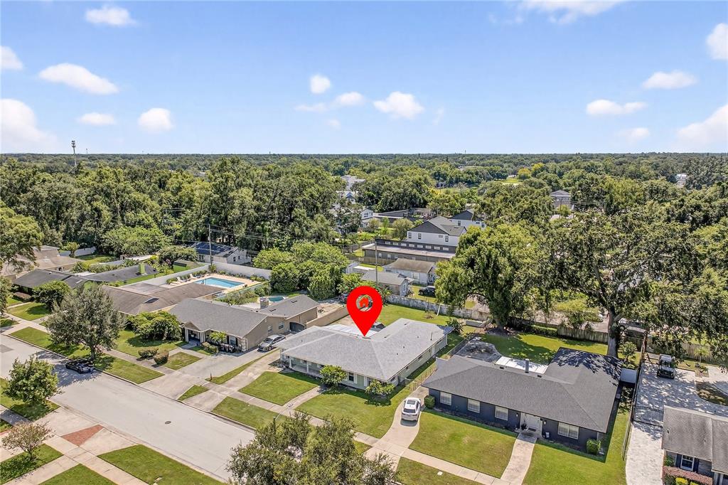 An aerial view shows a residential neighborhood with single-story houses, green lawns, and trees — 2502 VINE STREET, ORLANDO, FL